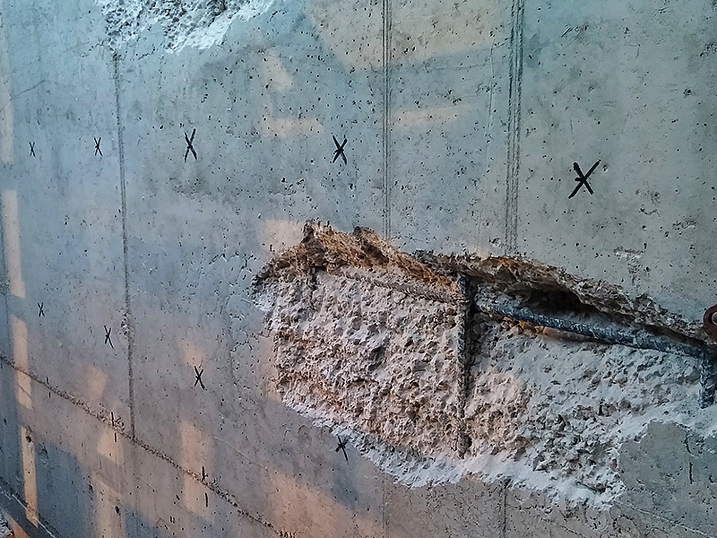 Concrete wall marked and repaired at defect points