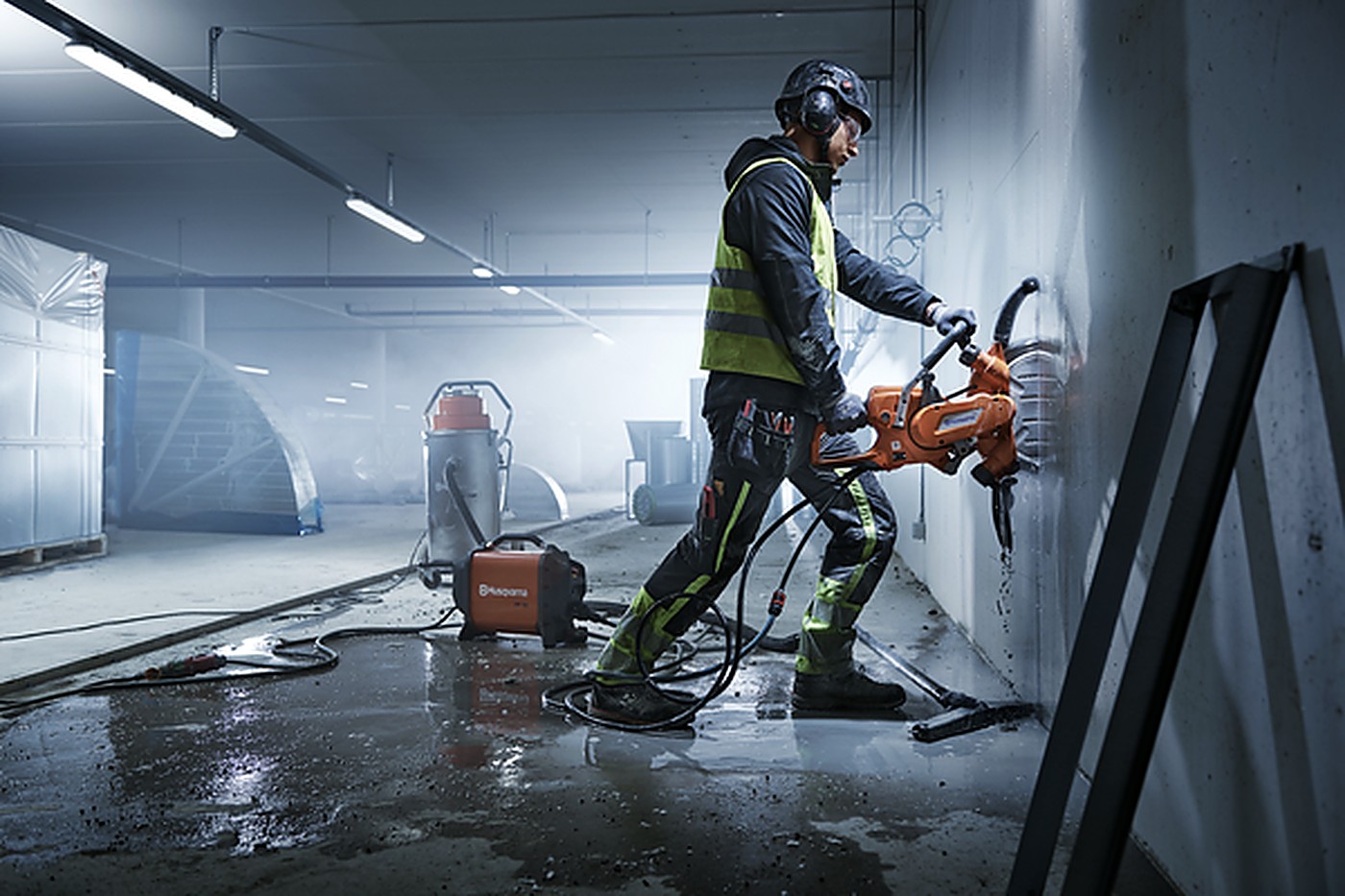 PCR Solutions technician grinding a concrete wall on an active job site