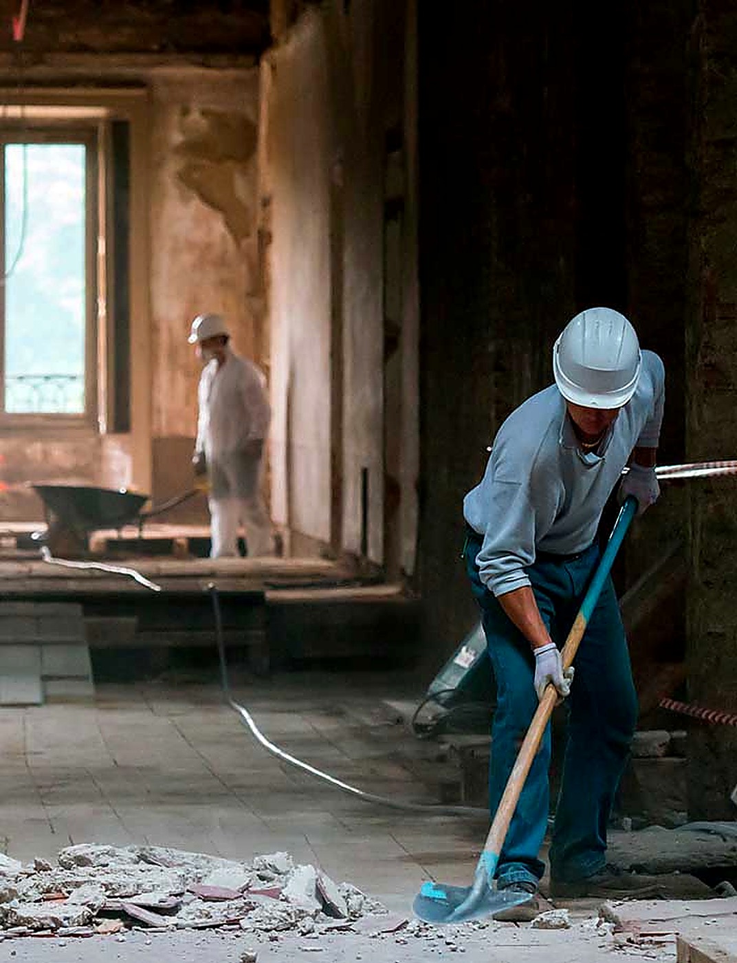Crew clearing and preparing a concrete floor surface